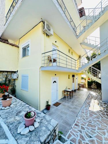 a courtyard of a house with a balcony at Potami Seashell in Himare