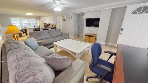 a living room with a couch and a table at Family Time by Tybee Vacation Rentals in Tybee Island