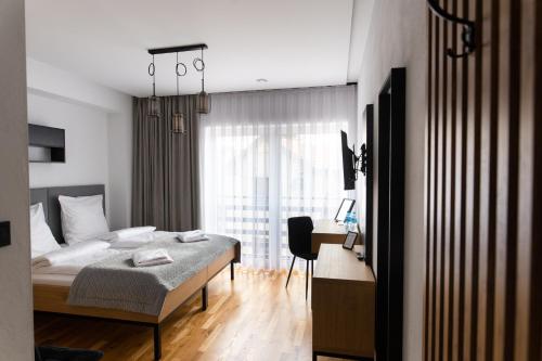 a bedroom with a bed and a desk in a room at Apartamenty Loftove in Wadowice