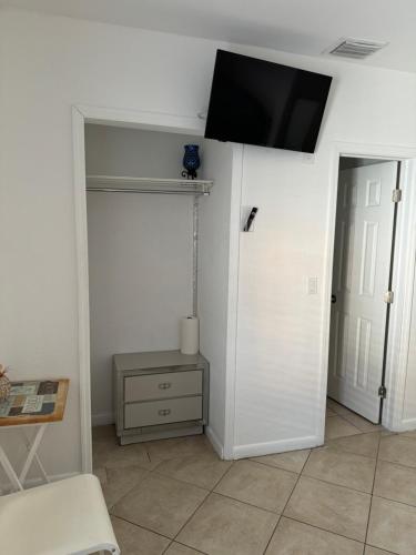 a living room with a tv on the wall at B2 Best Value on Private Bedroom with Private Bathroom in Little Havana, Miami in Miami