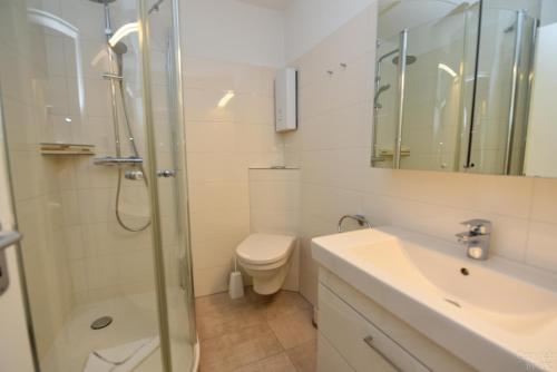 ein Badezimmer mit Dusche, Toilette und Waschbecken in der Unterkunft "Appartementhaus Deichgraf" Appartement D445 in Döse