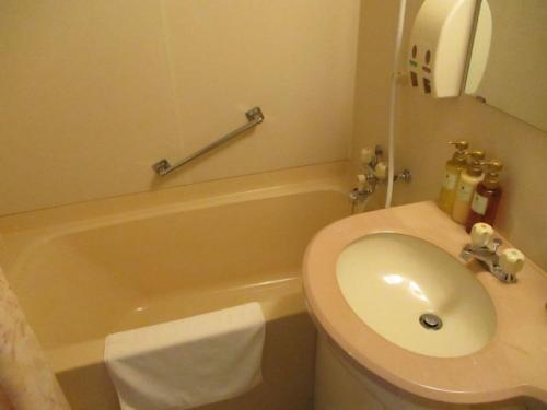 a bathroom with a sink and a toilet and a tub at Hotel Heart INN Hakodate - Vacation STAY 56676v in Hakodate