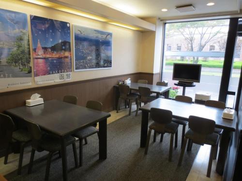 a waiting room with tables and chairs and a tv at Hotel Heart INN Hakodate - Vacation STAY 56676v in Hakodate