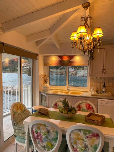 a kitchen with a table with chairs and a chandelier at Dream House Efi in Ravdhoúkha