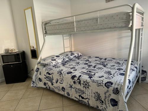 a bedroom with a bunk bed with a floral bedspread at B2 Best Value on Private Bedroom with Private Bathroom in Little Havana, Miami in Miami