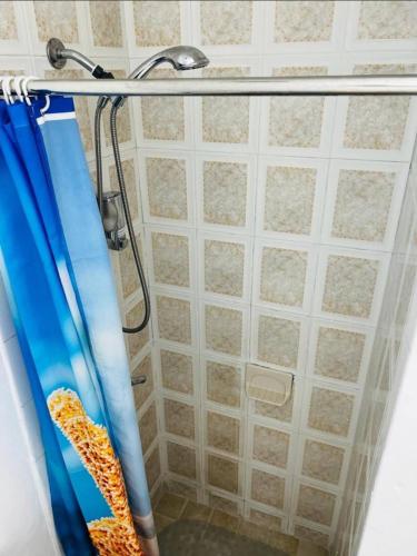 a shower with a blue shower curtain in a bathroom at B3 Best Value on Private Bedroom with Private Bathroom in Little Havana, Miami in Miami