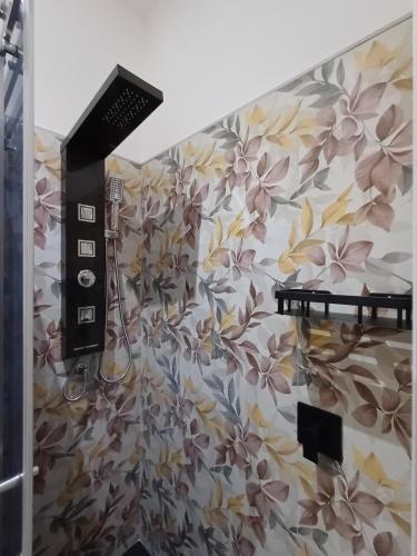 baño con una pared con estampados florales en La Siesta 5 terre, en La Spezia