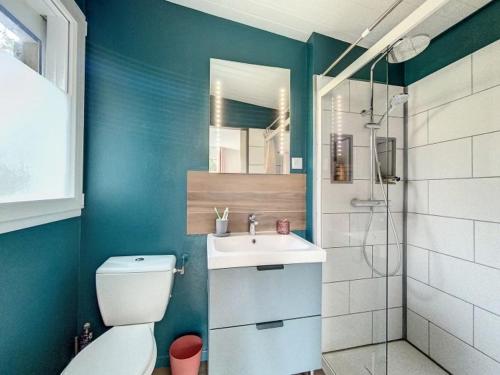 a bathroom with a toilet and a sink and a shower at Maison avec terrasse à quelques minutes de la place Morny in Deauville