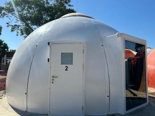 a large white dome tent with a door at Iglú Gulliver a 6 minutos de la playa en auto in Barra de Navidad