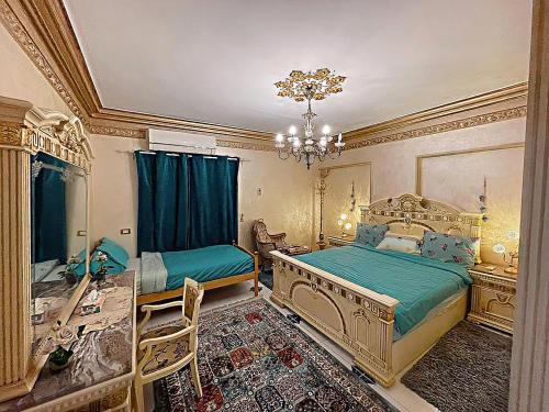 a bedroom with two beds and a chandelier at LuXury Apartment Nasr City - CityStars in Cairo
