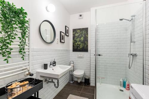 a bathroom with a sink and a toilet and a shower at Stylish Oasis Central Apartment with AC and Parking in Budapest
