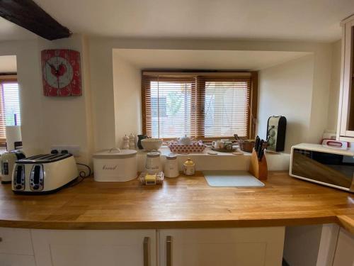 a kitchen with a wooden counter top with a microwave at The Apple Press - Sweethay in Taunton