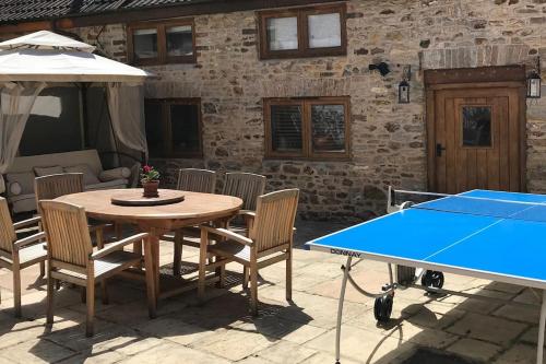 a ping pong table and chairs with a ping pong ball at The Apple Press - Sweethay in Taunton