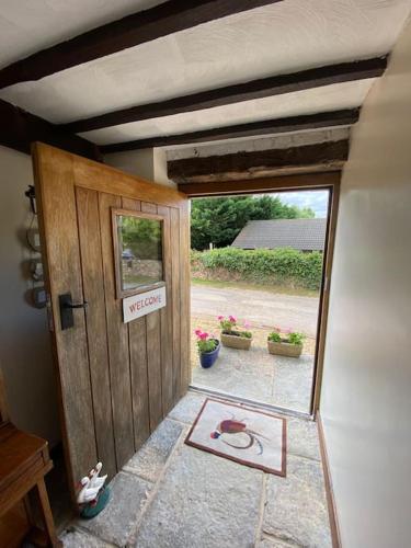 a door to a house with a sign on it at The Apple Press - Sweethay in Taunton