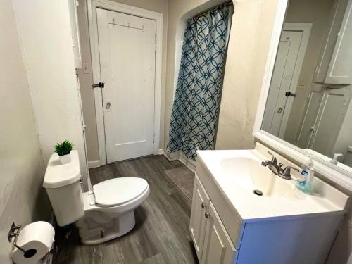 a bathroom with a toilet and a sink and a mirror at Hollywood Gem 2 Bed Haven! in Los Angeles