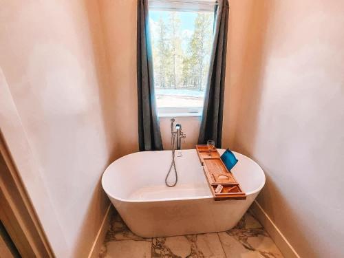 a bath tub in a bathroom with a window at Pet Friendly Rancher Brand New on 40 Acres in Leadville