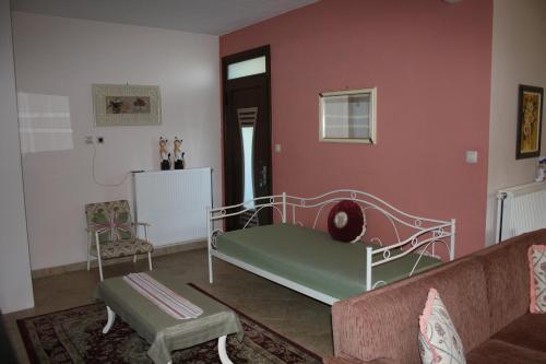 a living room with a bed and a couch at Κατάλυμα στην Καστοριά in Kastoria