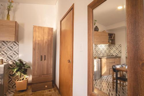 a hallway with a mirror and a door in a room at Casa estudios Normandia in Bogotá