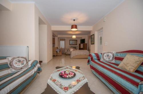 a living room with two couches and a table at Afrodite's Oasis Villa by "elite" in Akrotiri
