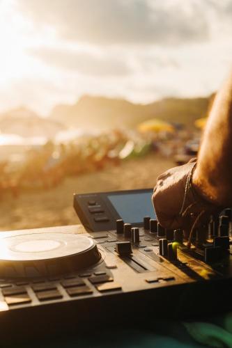 a person is playing a music keyboard in the desert at Che Zipolite Hostel & Beach Club in Zipolite