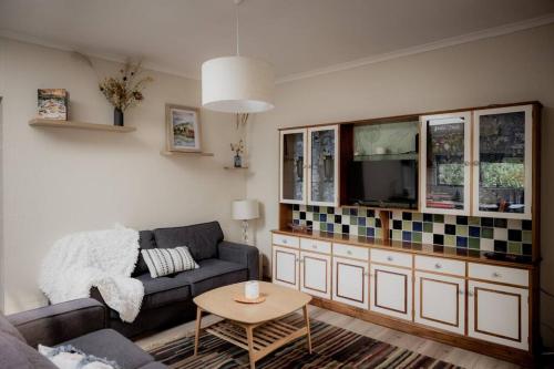a living room with a couch and a tv at Twelve 30 - Easy Airport Access in Cambridge