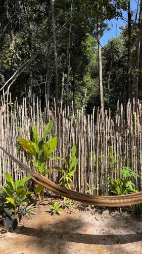 a bench in front of a bamboo fence at Cabana Ewaré in Presidente Figueiredo