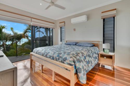 a bedroom with a bed with a view of the ocean at Marlin Lodge in Tangalooma