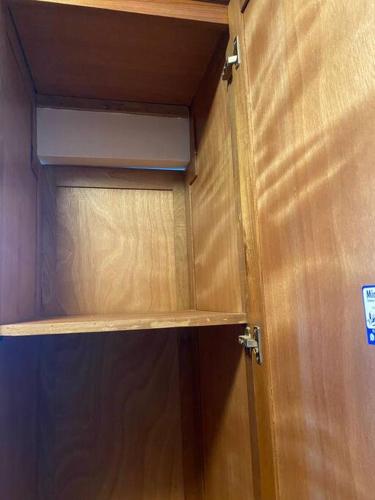 a wooden cabinet in a room with a door at Luxury Penthouse Santo Domingo W in Santo Domingo