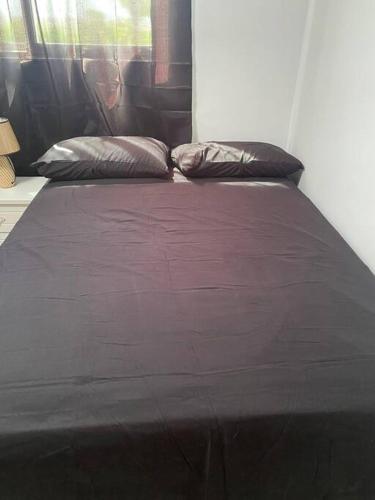 a bed with two pillows on it in a room at Luxury Penthouse Santo Domingo W in Santo Domingo