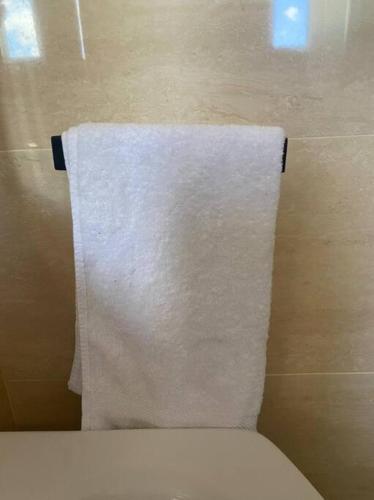 a towel hanging above a toilet in a bathroom at Luxury Penthouse Santo Domingo W in Santo Domingo