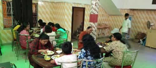 a group of people sitting at tables eating food at Sea Land Mandarmani in Mandarmoni