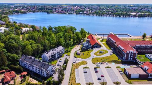 an aerial view of a building next to a lake at Lake Chill - MAZURIA APARTAMENTY in Ostróda