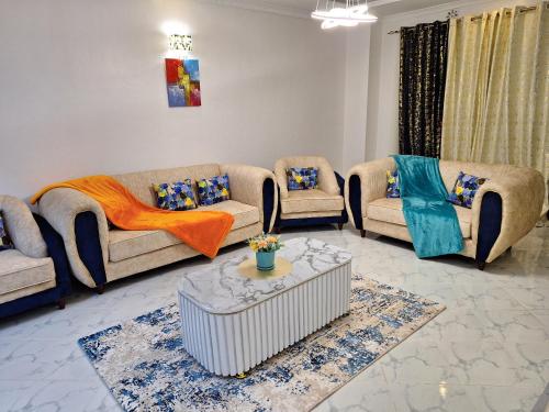 a living room with couches and a table at Mellow Homes 3 - Own compound in Kitengela 