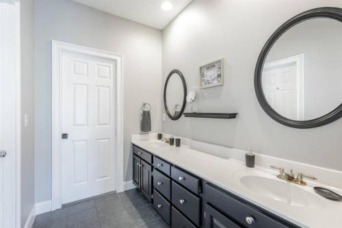 a bathroom with a sink and a mirror at Pickleball - Pool - Hot Tub - Gym - BBQ in Cenchat