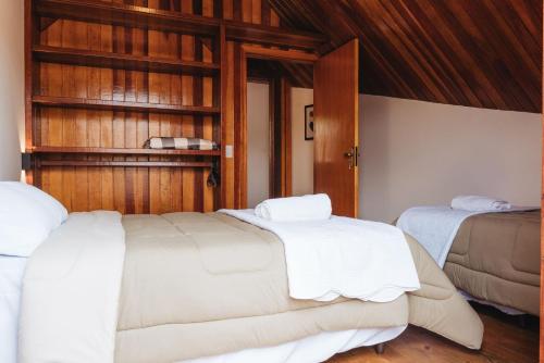 Postel nebo postele na pokoji v ubytování Chalé Florestal - Tranquilidade e conforto próximo ao Horto Florestal