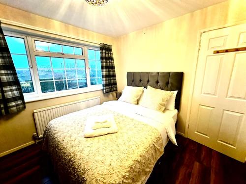 ein Schlafzimmer mit einem Bett mit zwei Handtüchern darauf in der Unterkunft Coniston Green Holiday Home in Wetherby