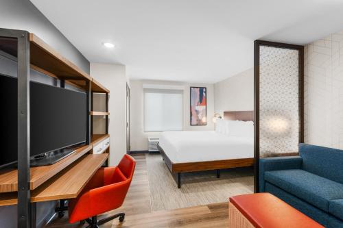 a hotel room with a bed and a tv at Everhome Suites Lexington - Horse Park in Lexington