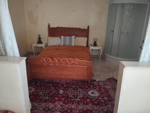 a bedroom with a bed and a red rug at شقة المنظر الجميل in Midelt