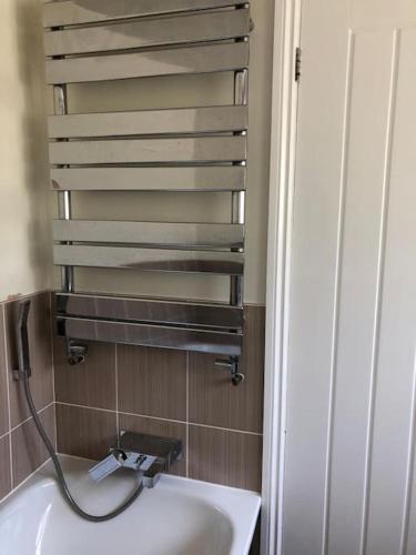 a bathroom with a sink and a faucet at Iris Cottage in Whitstable