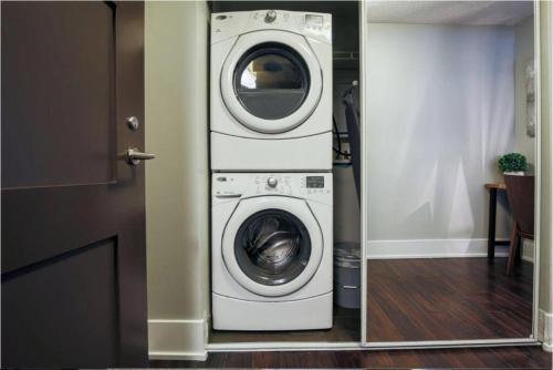 a washer and dryer sitting in a room at Residence Inn by Soho in Toronto