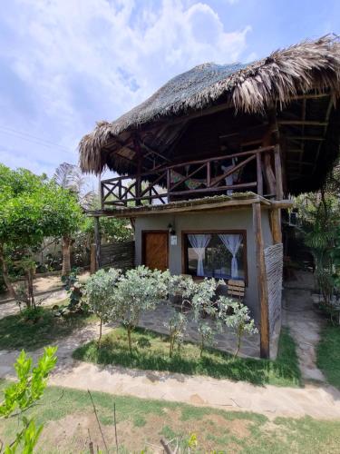 a small house with a thatched roof at Kite Eco House in Salina de Rey