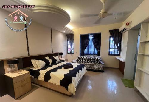 a bedroom with a bed and a couch in it at JRC Homestay PJ 1310 Permas Jaya in Johor Bahru