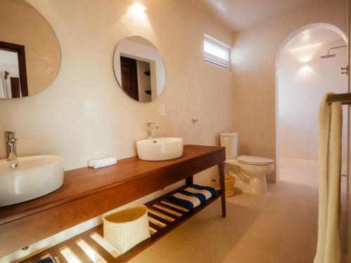 a bathroom with a sink and a toilet at Casona del Sol in Puerto Escondido