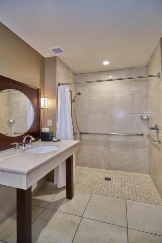 a bathroom with a sink and a shower at Sheraton Mesa Hotel at Wrigleyville West in Mesa