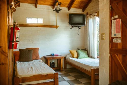 Postel nebo postele na pokoji v ubytování Cabañas Las Grullas