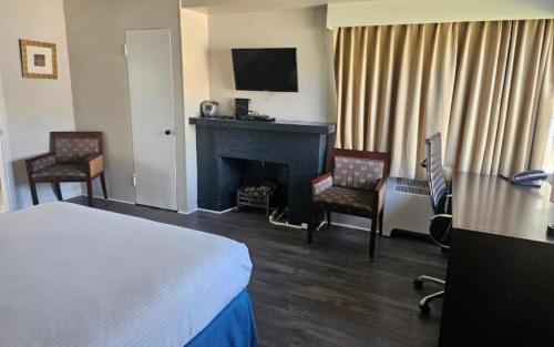 a hotel room with a bed and a fireplace at 2400 Motel in Vancouver