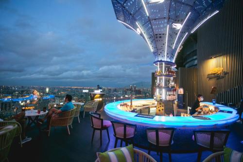 a bar in a building with people sitting at tables at Centara Grand At CentralWorld in Bangkok