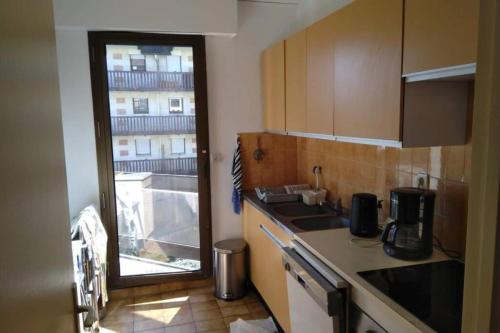 une cuisine avec un évier et une fenêtre dans l'établissement Spacious apartment in front of the sea, à Deauville