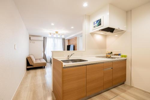 a kitchen with a sink and a counter at 渋谷 広め50m2 2LDK 代々木公園駅徒歩5分 家族におすすめ in Tokyo