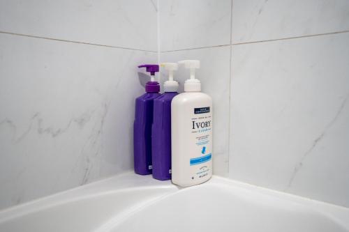 two bottles of detergent sitting on top of a bathroom sink at 7BR house 19 ppl DT Windsor WD Free Parking in Windsor